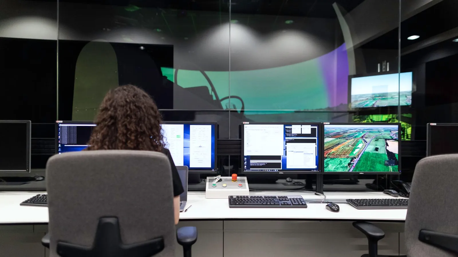 An operator watching several monitors in a control room