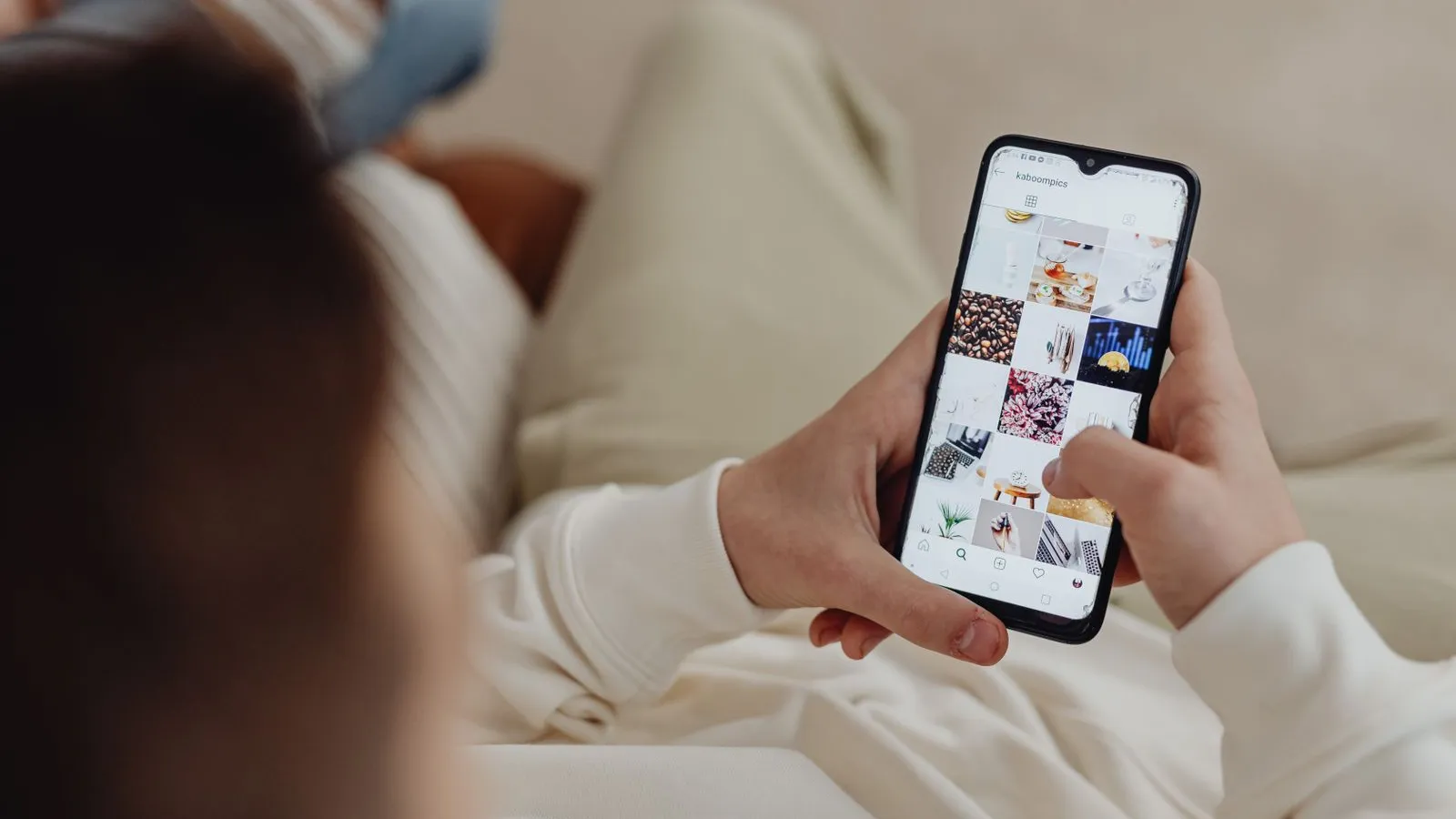 A person scrolls an image feed on a smartphone
